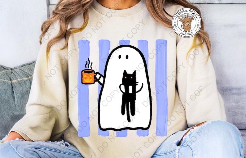 May include: A beige crewneck sweatshirt featuring a graphic print of a white ghost holding an orange mug with a jack-o'-lantern face and hugging a black cat. The design is set against a background of vertical light blue brushstroke stripes.