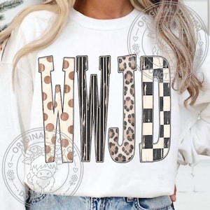 May include: A white long-sleeve sweatshirt featuring the letters WWJD printed on the front. Each letter has a distinct pattern: the Ws feature brown polka dots and black vertical stripes, the J has a leopard print, and the D has a black and white checkerboard pattern.
