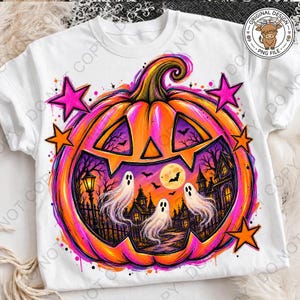 May include: A white t-shirt featuring a large, vibrant orange pumpkin graphic. The pumpkin contains a scene with three white ghosts, a full moon, bats, and a haunted house. The design is accented with bright pink and orange stars and splatters.