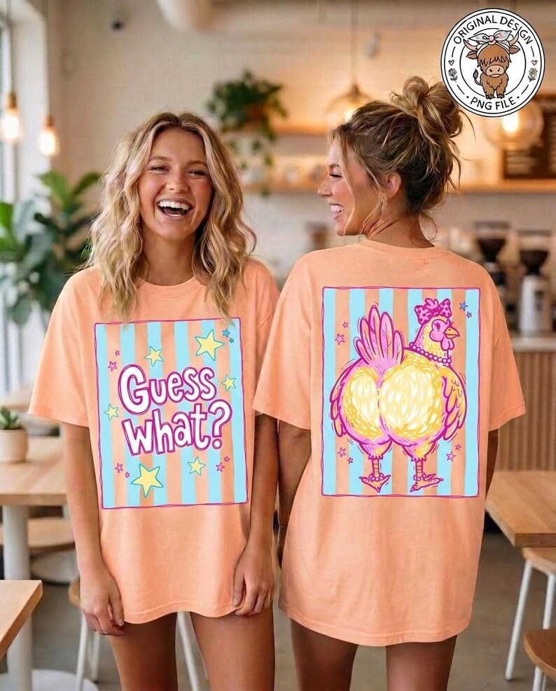 May include: Peach-colored t-shirts with a graphic design. The front of the shirt says "Guess What?" in a playful font, surrounded by stars. The back features a cartoon chicken with a pink bow and necklace.