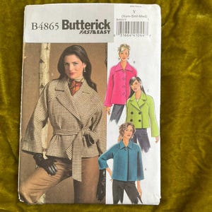 May include: Butterick B4865 sewing pattern showing a woman in a houndstooth jacket with a tie belt. The pattern includes illustrations of different jacket styles in pink, green, and blue. The pattern is labelled "FAST & EASY".