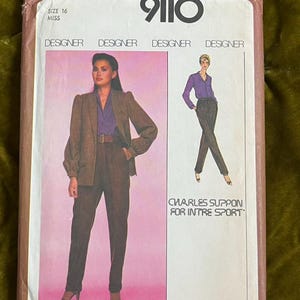 May include: A Simplicity 9110 sewing pattern envelope for size 16 miss. The front features a photograph of a blazer and trousers, with an illustration of the same outfit labelled Charles Suppon for Intre Sport. The background is a gradient pink.