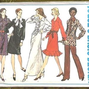 May include: A Vogue's Basic Design sewing pattern envelope 2749 featuring illustrations of five different outfits including dresses and a pantsuit. The designs showcase various collar styles, sleeve lengths, and fabric patterns in a vintage fashion illustration style.
