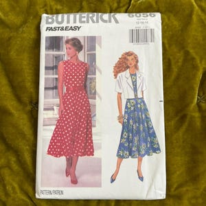 May include: Butterick Fast & Easy sewing pattern 6056. The pattern features illustrations of two dresses: a red polka dot dress and a blue floral dress. The pattern size is 12-14-16.