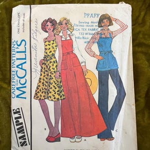 May include: Vintage McCall's sewing pattern envelope featuring illustrations of women in aprons and dresses. The envelope includes the text "Misses' Butcher Apron" and "Carefree Patterns". The background is a green velvet.