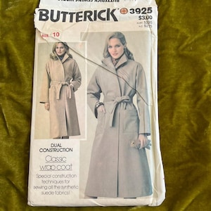 May include: A vintage Butterick sewing pattern, size 10, for a classic wrap coat. The pattern features a dual construction design and special techniques for sewing synthetic suede fabrics. The cover shows a woman wearing the coat in a light tan color.