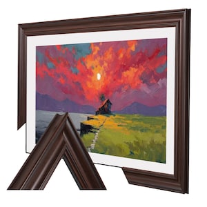 May include: A framed landscape painting depicts a sunset over a small house on a cliff. The sky is filled with vibrant red and orange hues, with a bright moon. The painting is set in a dark brown wooden frame.