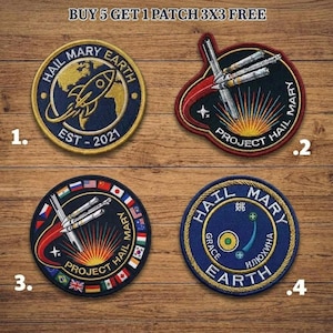 May include: Four embroidered patches with space-themed designs. The patches feature rockets, planets, and the text "Hail Mary Earth" and "Project Hail Mary." The patches are in navy blue, gold, red, and white. The text "Buy 5 Get 1 Patch 3x3 Free" is at the top.