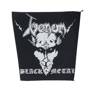 May include: A black fabric patch featuring a white graphic print of a goat head with a pentagram on its forehead. The word Venom is printed in a stylized font above the goat, and the words Black Metal are printed in a gothic font below.