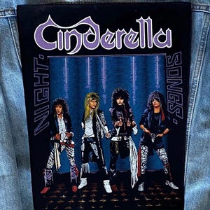 May include: A black patch featuring the band Cinderella with the text "Night Songs." The image shows four band members in rock attire against a blue background. The Cinderella logo is in purple.