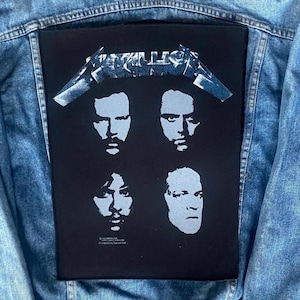 May include: A black patch with the Metallica logo and four band member portraits in light blue. The patch is sewn onto a denim jacket.