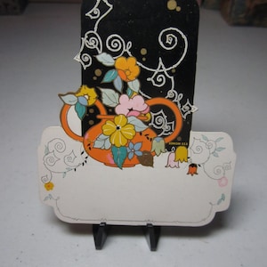 Gorgeous 1920&#39;s unused art deco gold gilded die cut Dennison&#39;s place card bright orange vase filled with flowers against black background