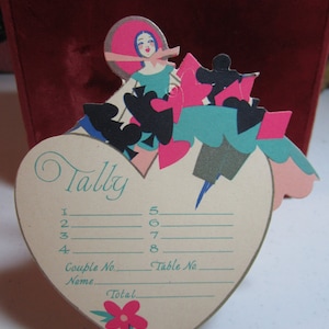Gorgeous 1920&#39;s-30&#39;s art deco die cut silver gilded unused heart shaped bridge tally deco lady in pink bonnet at the top in colorful dress