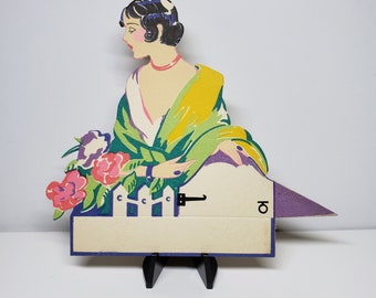 Gorgeous Art Deco 1920's-30's unused die cut Gibson place card deco lady with bobbed hair in deco clothing by gate with flowers