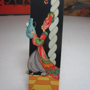 1920&#39;s art deco colorful unused die cut Gibson bridge tally card shows a genie in colorful turban and coat holds vessel artist signed N.F.S.