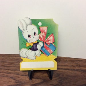 Sweet unused colorful die cut 1940s easter gift card hang tag cute white bunny with big cotton tail and dressed up holds a colorful gift image 2