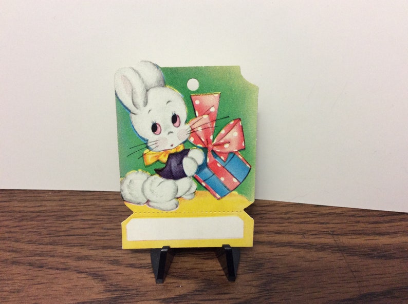 Sweet unused colorful die cut 1940s easter gift card hang tag cute white bunny with big cotton tail and dressed up holds a colorful gift image 2