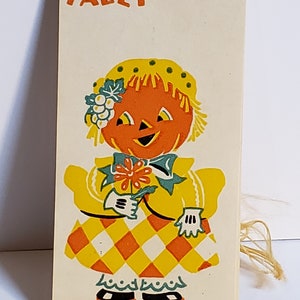 1930&#39;s unused colorful Dennison halloween bridge tally anthropomorphic lady jack o&#39; lantern wearing a fancy hat  and dress with pantaloons