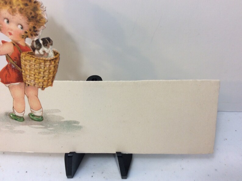 Adorable unused 1920/'s die cut Germany place card sweet little girl holds puppy looks over her shoulder at other puppy in basket on her back