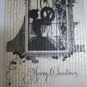 Gorgeous unused art deco christmas card on parchment silhouette of lady hanging wreath at a window  silver gilded w/ envelope