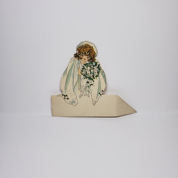 Adorable unused die cut Newman pub.co. Bride wedding place card rosy cheeked flapper bride with bobbed hair long veil, flower bouquet Saxony