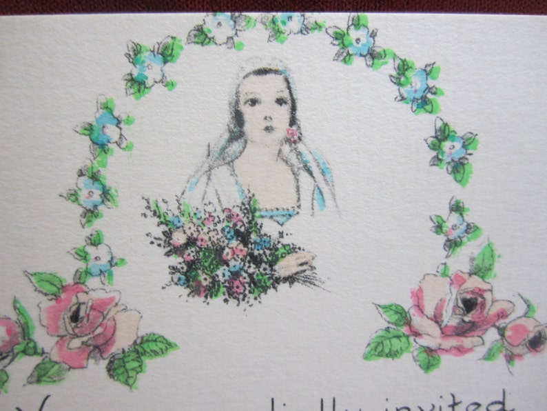 May include: A vintage wedding invitation with a woman in a white dress holding a bouquet of flowers. The woman is surrounded by a wreath of blue flowers and green leaves. The text "You are invited" is visible at the bottom of the card.