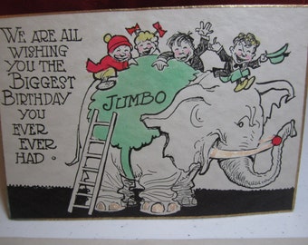 Cute 1920's unused hand colored gold gilded birthday card with group of kids sitting on an angry Jumbo elephant with tusks original envelope