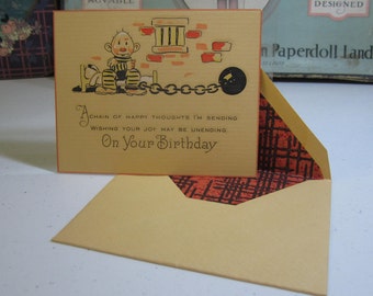 Art Deco 1930's unused Birthday card with matching art deco tissue lined envelope hand colored graphics of a prisoner with a ball and chain