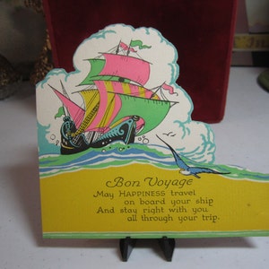 Colorful unused art deco die cut 1920's-30's Bon Voyage greeting card pink, green, yellow sailing ship seagull cloud bursts