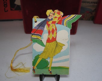 Art deco die cut unused colorful 1920's The Henderson Line bridge tally flapper girl swinging a golf club in cute deco golfing outfit