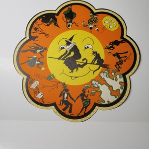 Unused mint 1920’s die cut Whitney halloween paper doily table decoration black cats, witch flying on broom, ghosts,graveyard,cauldron,owl