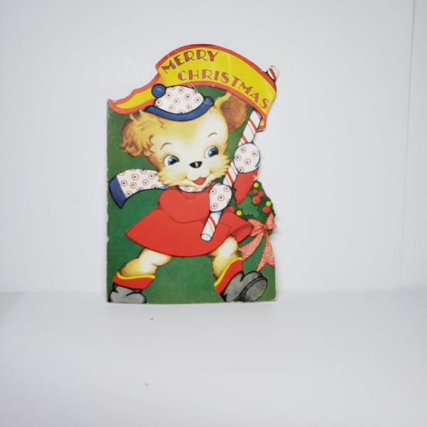 Adorable 1930's-40's die cut embossed  juvenile Christmas card anthropomorphic dressed up puppy holds candy cane with Merry Christmas banner