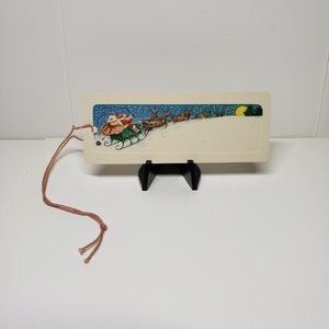 Vintage unused 1920&#39;s embossed Dennison Christmas gift card hang tag Santas reindeer pulling him in his sleigh at night stars full moon