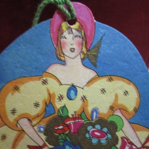 1920&#39;s Art Deco Die Cut Bridge Tally card  gorgeous girl in elaborate dress and bonnet holding bouquet gold gilded hallmark