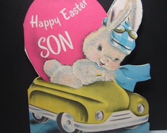 Darling 1952 die cut colorful flocked Norcross easter card to son bunny rabbit driving yellow convertible giant pinkEaster egg in backseat