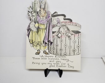 Colorful art deco die cut 1920's-30's easter greeting card shows an anthropomorphic rabbit dressed as a delivery boy with pot of lilies