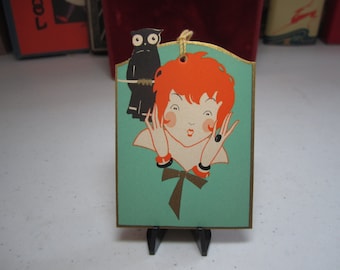 Colorful 1920&#39;s unused die cut gold gilded Gibson Halloween bridge tally cute redheaded flapper surprised by black owl behind her