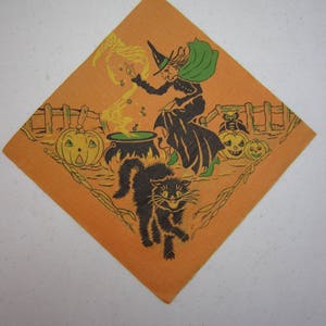 May include: Orange Halloween-themed napkin with a witch stirring a cauldron, a black cat, and jack-o'-lanterns. The witch wears a black dress, green cape, and pointed hat. The cat has an arched back and a menacing grin.