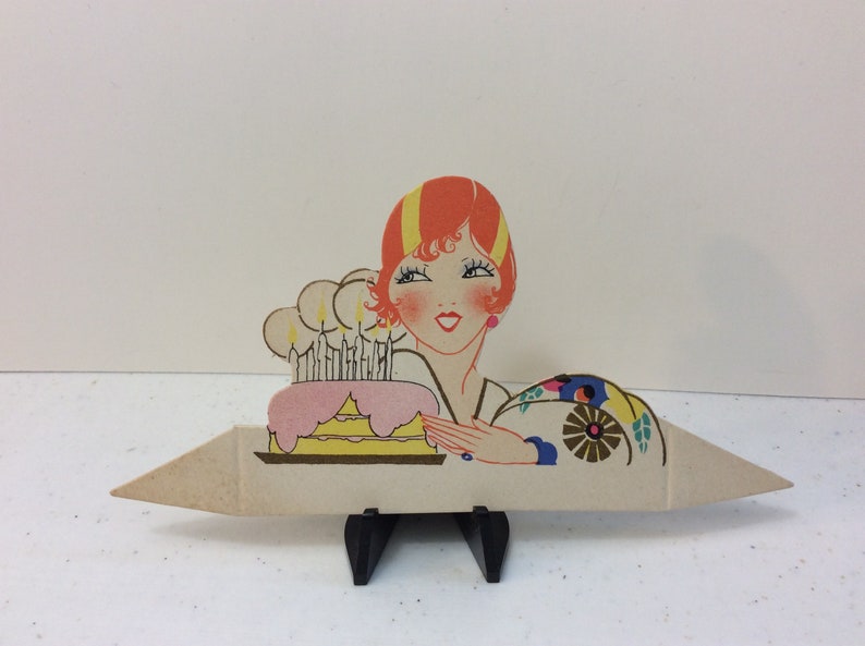 1920/'s unused gold gilded die cut Clark place card deco flapper lady next to pink and yellow Birthday cake with lit candles