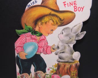 Darling 1950's Hallmark die cut colorful easter greeeting card cute boy in cowboy hat and  boots holds giant colored egg shaking bunny’s paw