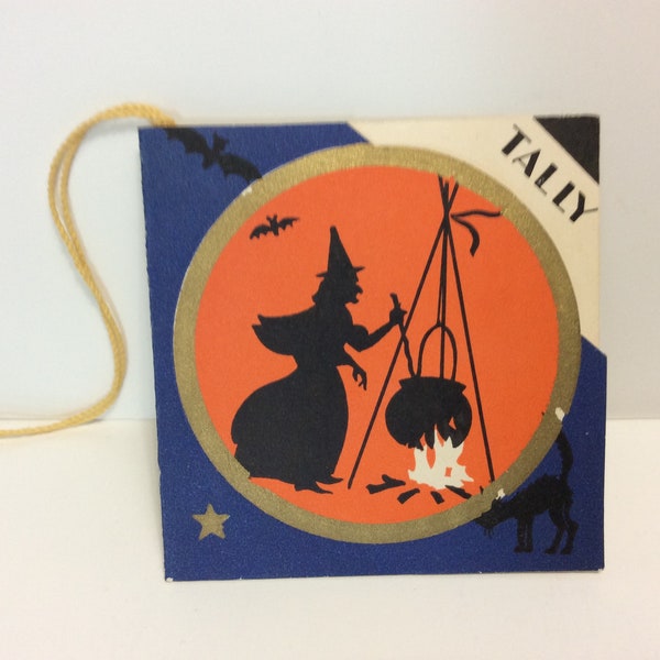 Vintage 1942 die cut gold gilded Halloween bridge tally card with patriotic colors witch stirring her cauldron black bats,cat, and gold star