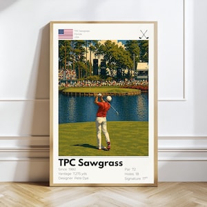 May include: A framed poster featuring a golf course scene with a golfer in action. The poster includes the text "TPC Sawgrass" and details such as yardage and designer. The American flag is visible in the upper left corner. The poster is in a wooden frame.