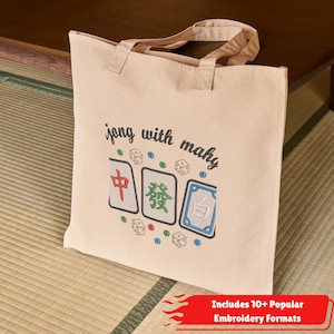 May include: A beige canvas tote bag with the words "jong with mahy" above a graphic of three Mahjong tiles and dice. The tiles are red, green, and blue. The bag has two handles and a red banner at the bottom.
