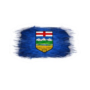 May include: A sticker featuring the flag of Alberta, Canada. The flag is set against a blue brushstroke background. The flag's emblem includes a red cross, mountains, and a field of wheat.