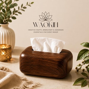May include: A rectangular dark brown wooden tissue box holder with rounded edges, containing a white tissue. Above the box, the text reads WAOKIN, with the subtitle CREATIVE CRAFTS, EMBROIDERY & HANDMADE ESSENTIALS FOR EVERY MAKER and a lotus icon.