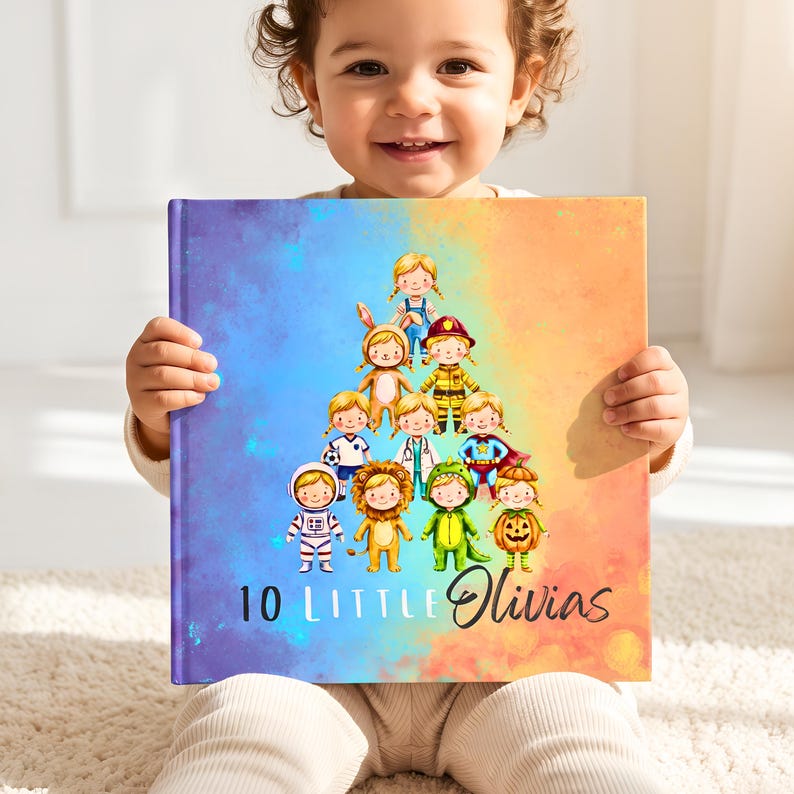 May include: A square hardcover book with a blue and orange gradient background. The cover features a pyramid-shaped illustration of ten children in various costumes, including an astronaut, a lion, and a pumpkin. The text reads 10 Little Olivias.