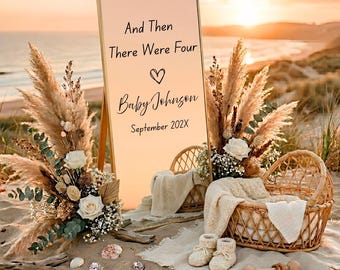 May include: A rectangular sign with a gold frame featuring the text And Then There Were Four, a heart symbol, Baby Johnson, and September 202X. It is decorated with pampas grass, white roses, a wicker basket, cream blankets, and baby booties.