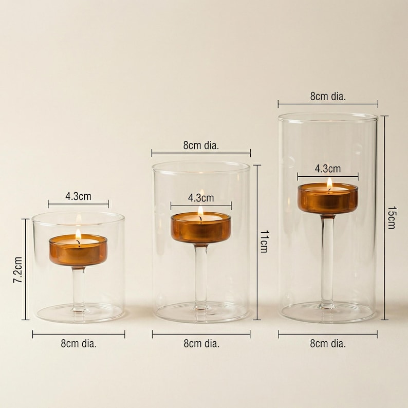 May include: Three clear glass candle holders with lit candles. The tallest is 15cm high, the middle is 11cm, and the shortest is 7.2cm. Each holder has an 8cm diameter and holds a 4.3cm candle. Ideal for home decor.