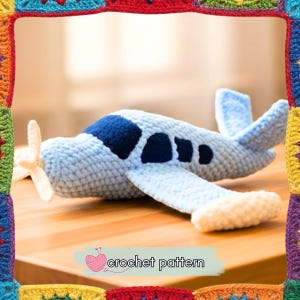 May include: A handmade crochet airplane in light blue, with a dark blue top and black window details. It features a white propeller and a cream-colored underside. The image includes the text "crochet pattern".