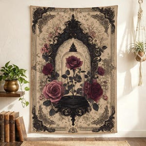 May include: A rectangular wall tapestry featuring a central illustration of a single rose inside a glass cloche, surrounded by larger blooming roses. The design is framed by an ornate black border on a beige background with intricate floral details.